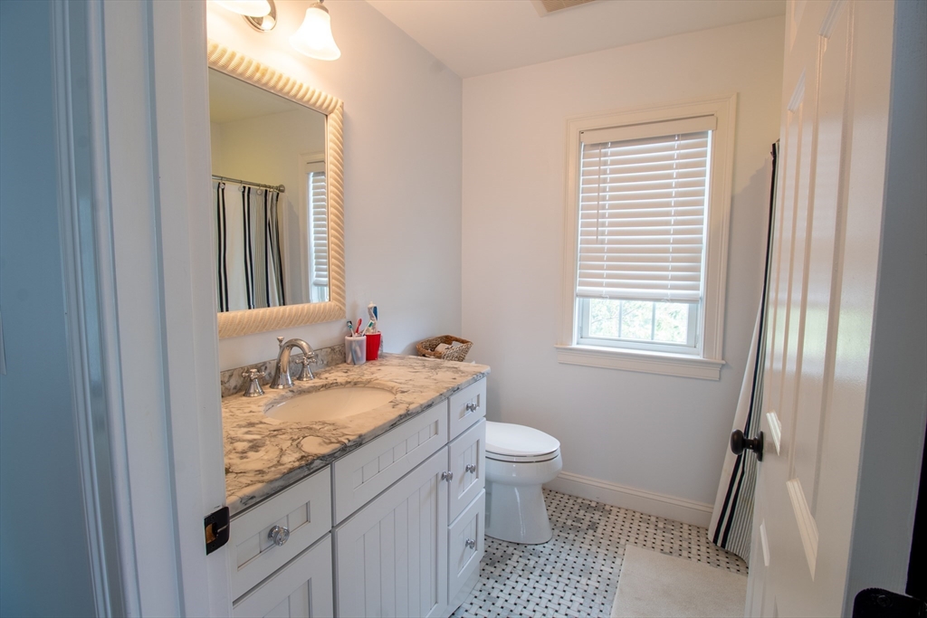 117 River Street Scituate, MA 02050 - Photo 13 of 23 a bathroom with a granite countertop sink and a mirror