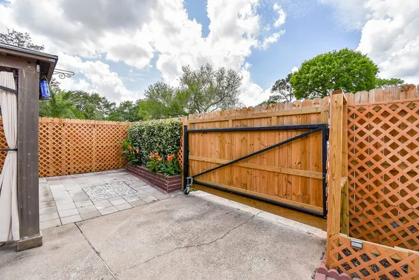 a view of an empty room with a fireplace and a window