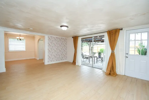 a view of empty room with wooden floor