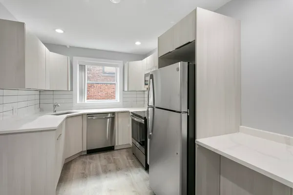 a kitchen with a refrigerator sink and stove