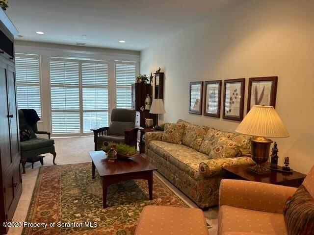 118 Wyndham Road Clarks Summit, PA 18411 - Photo 17 of 21 a living room with furniture fireplace and a window