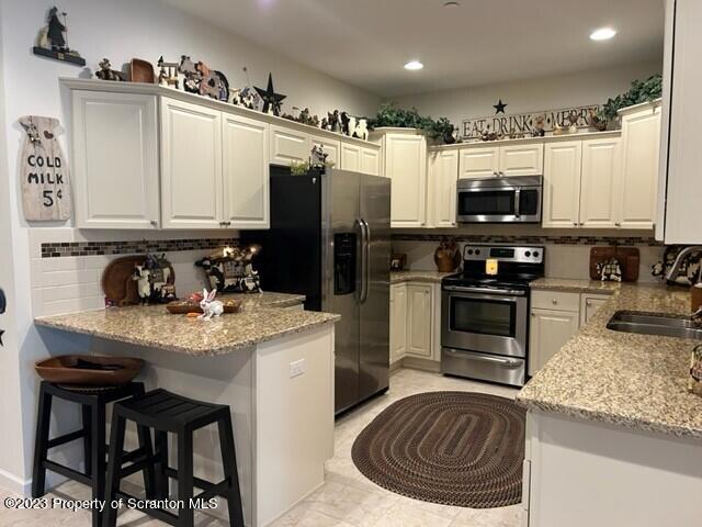 118 Wyndham Road Clarks Summit, PA 18411 - Photo 2 of 21 a kitchen with stainless steel appliances granite countertop a sink stove refrigerator and cabinets