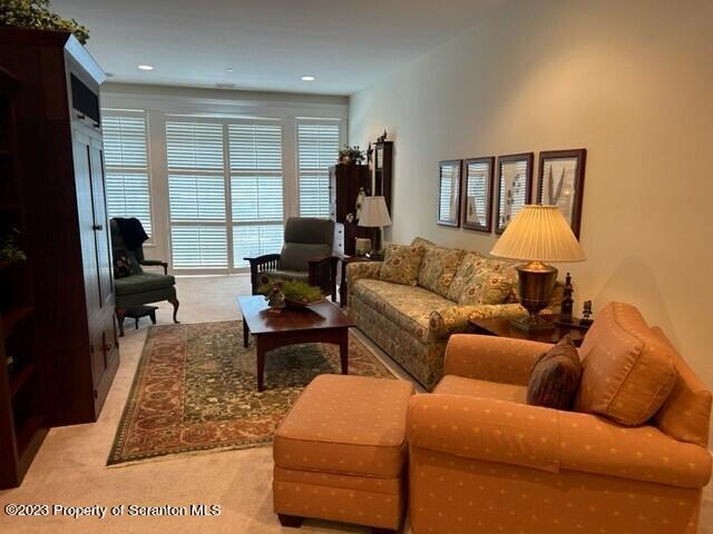 118 Wyndham Road Clarks Summit, PA 18411 - Photo 6 of 21 a living room with furniture ceiling fan and a rug