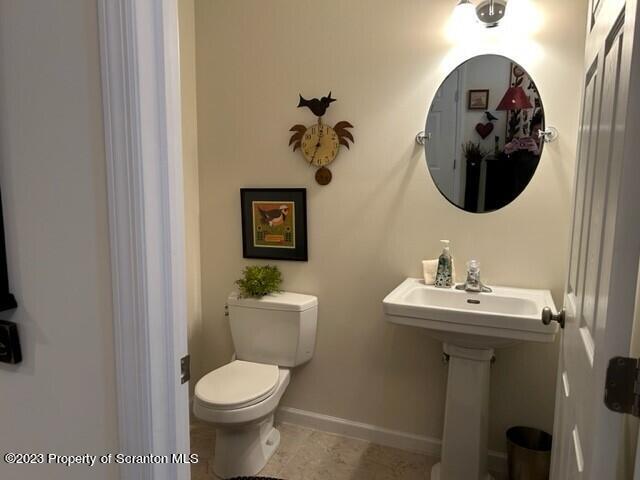 118 Wyndham Road Clarks Summit, PA 18411 - Photo 9 of 21 a bathroom with a toilet sink and mirror