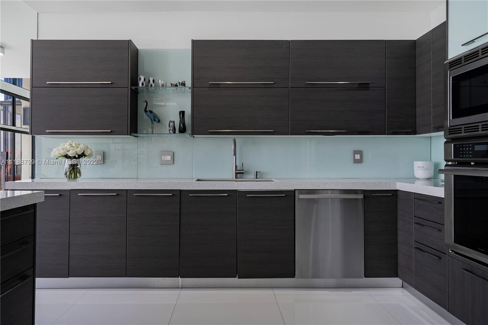 1925 Brickell Avenue, Unit DPH7 Miami, FL 33129 - Photo 11 of 37 a kitchen with a sink and a microwave