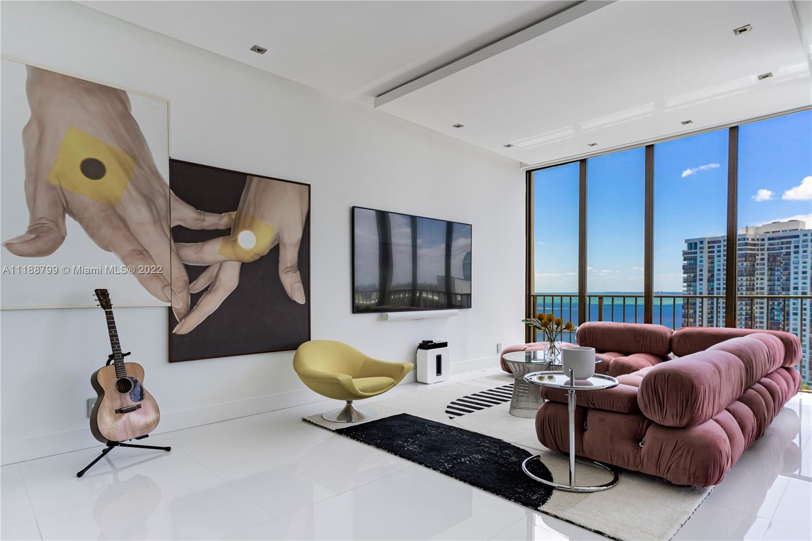 1925 Brickell Avenue, Unit DPH7 Miami, FL 33129 - Photo 12 of 37 a living room with furniture and a floor to ceiling window