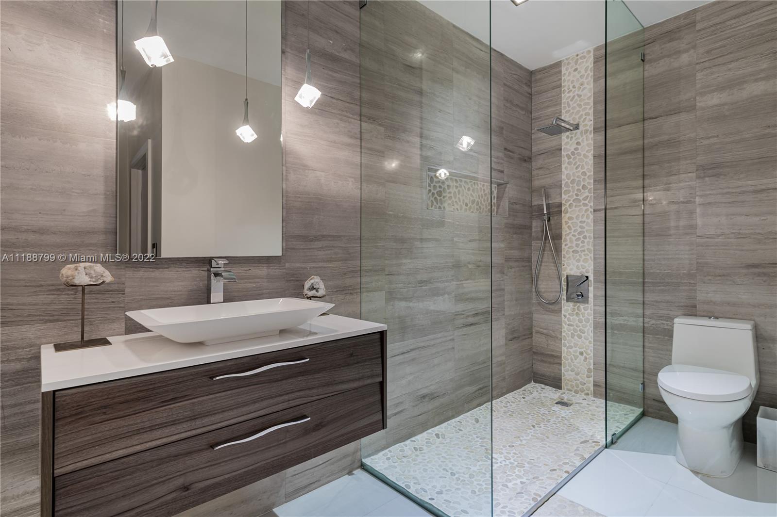 1925 Brickell Avenue, Unit DPH7 Miami, FL 33129 - Photo 15 of 37 a bathroom with a sink a toilet and shower