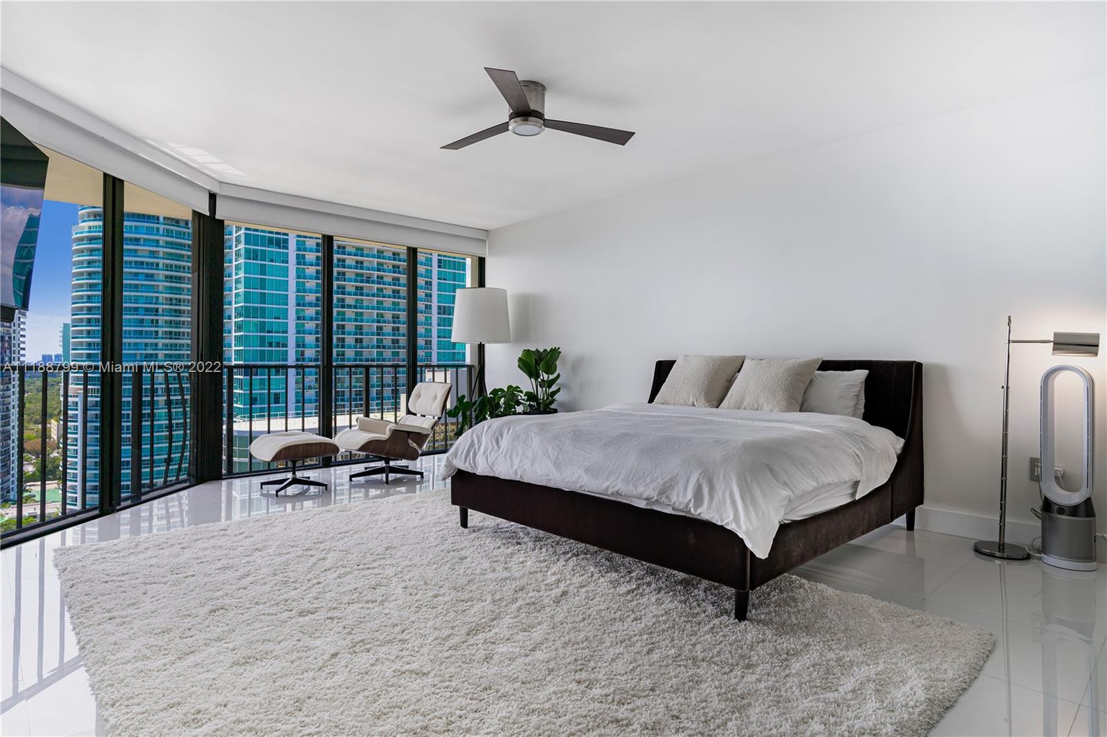 1925 Brickell Avenue, Unit DPH7 Miami, FL 33129 - Photo 21 of 37 a spacious bedroom with a bed and large windows