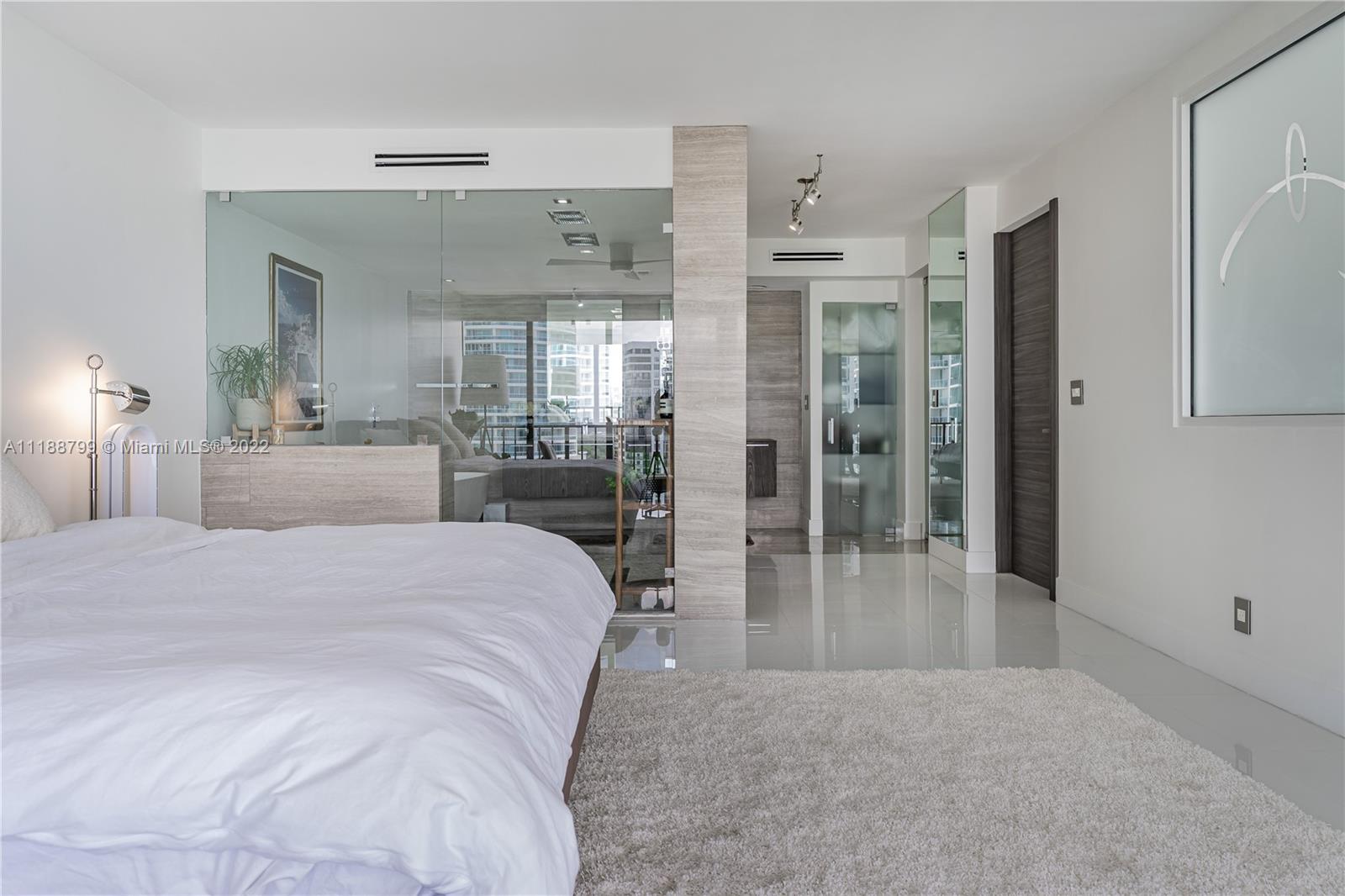 1925 Brickell Avenue, Unit DPH7 Miami, FL 33129 - Photo 23 of 37 a spacious bathroom with a granite countertop sink mirror and shower