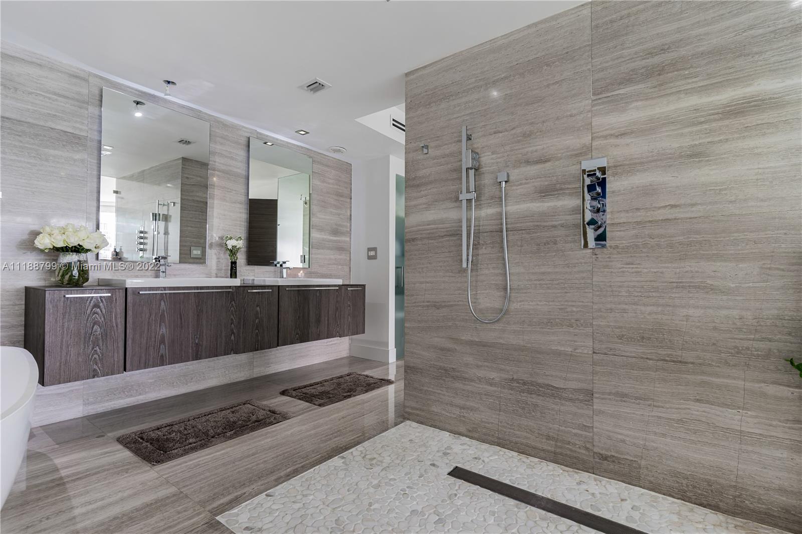 1925 Brickell Avenue, Unit DPH7 Miami, FL 33129 - Photo 24 of 37 a bathroom with a sink a mirror and shower