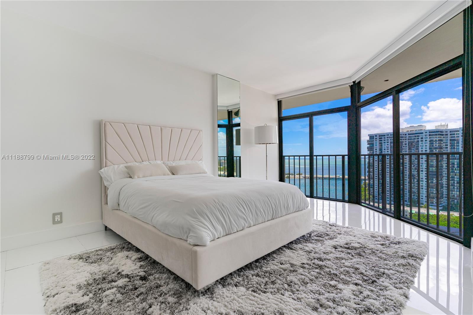 1925 Brickell Avenue, Unit DPH7 Miami, FL 33129 - Photo 26 of 37 a bed sitting in a bedroom next to a large window