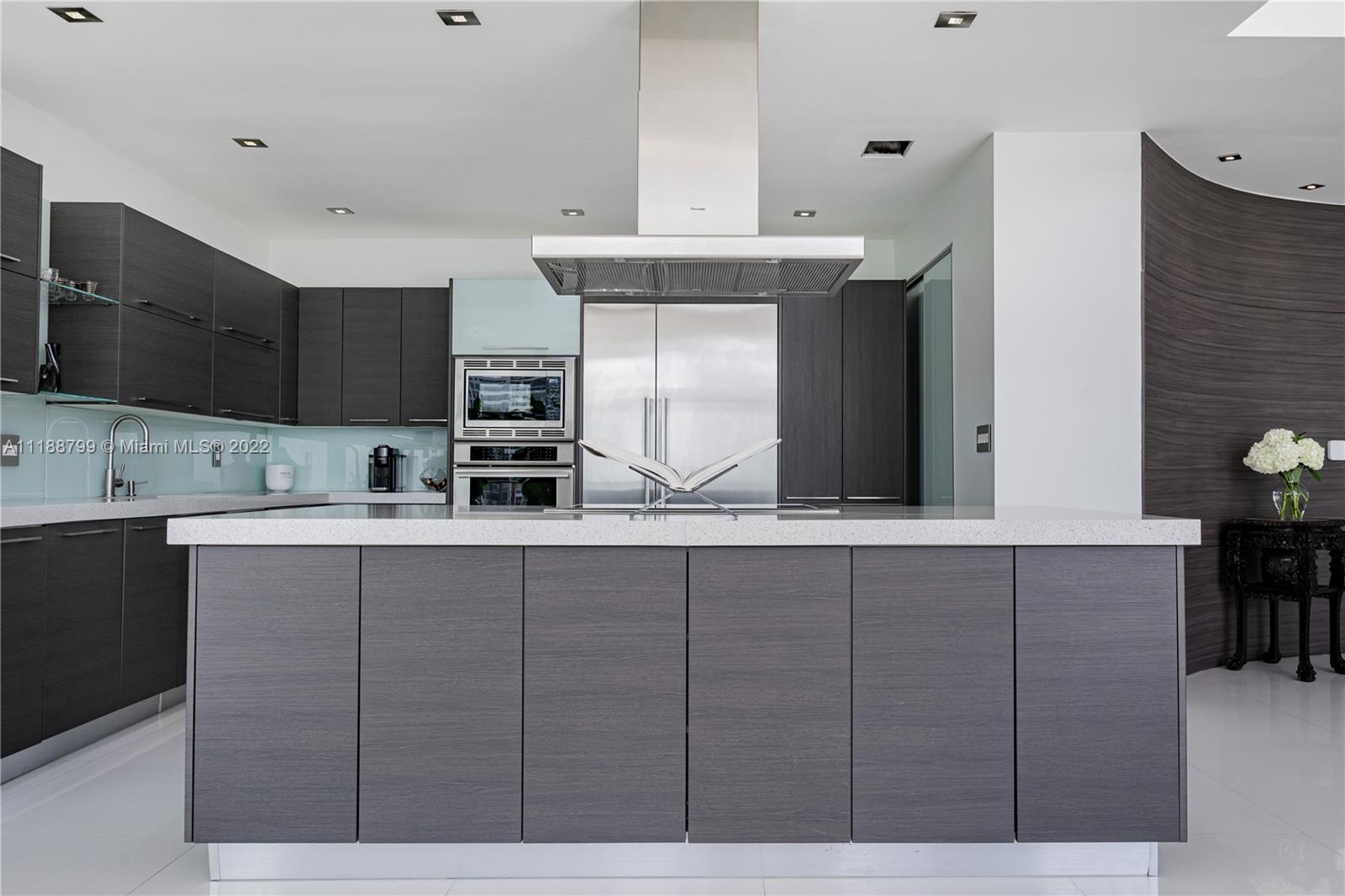 1925 Brickell Avenue, Unit DPH7 Miami, FL 33129 - Photo 9 of 37 a kitchen with stainless steel appliances a sink and cabinets