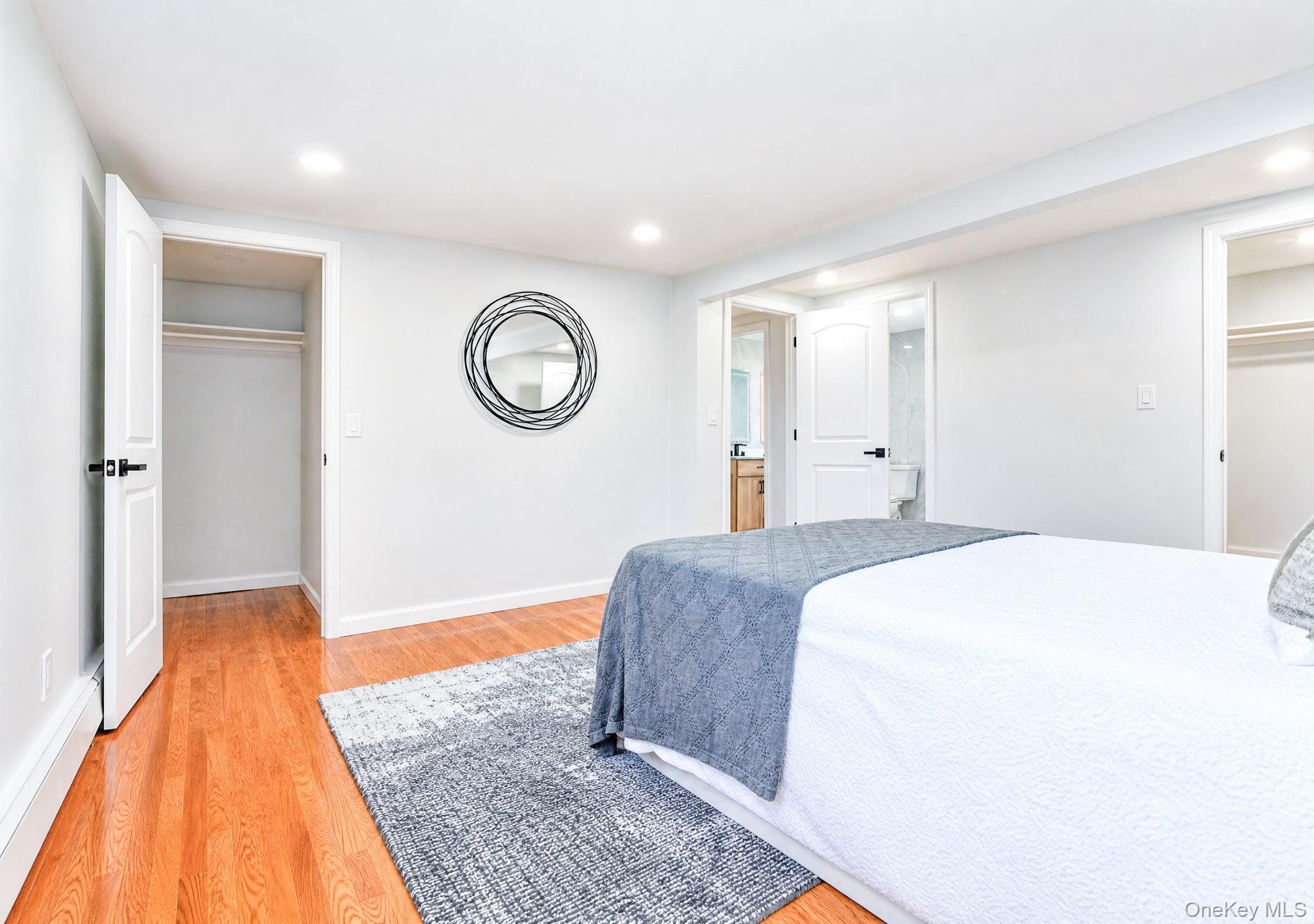 61 Cheshire Road Bethpage, NY 11714 - Photo 15 of 25 Hardwood flooring extends throughout this room, featuring recessed lighting and white baseboards