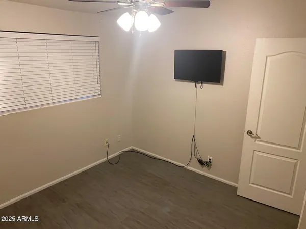 a room with a flat screen tv and a window
