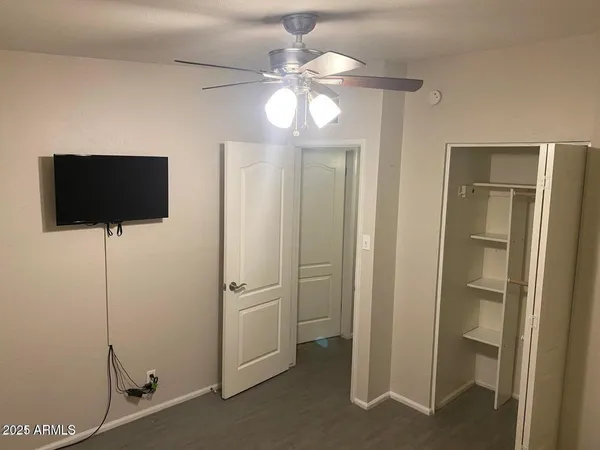 a room with a flat screen tv and a chandelier