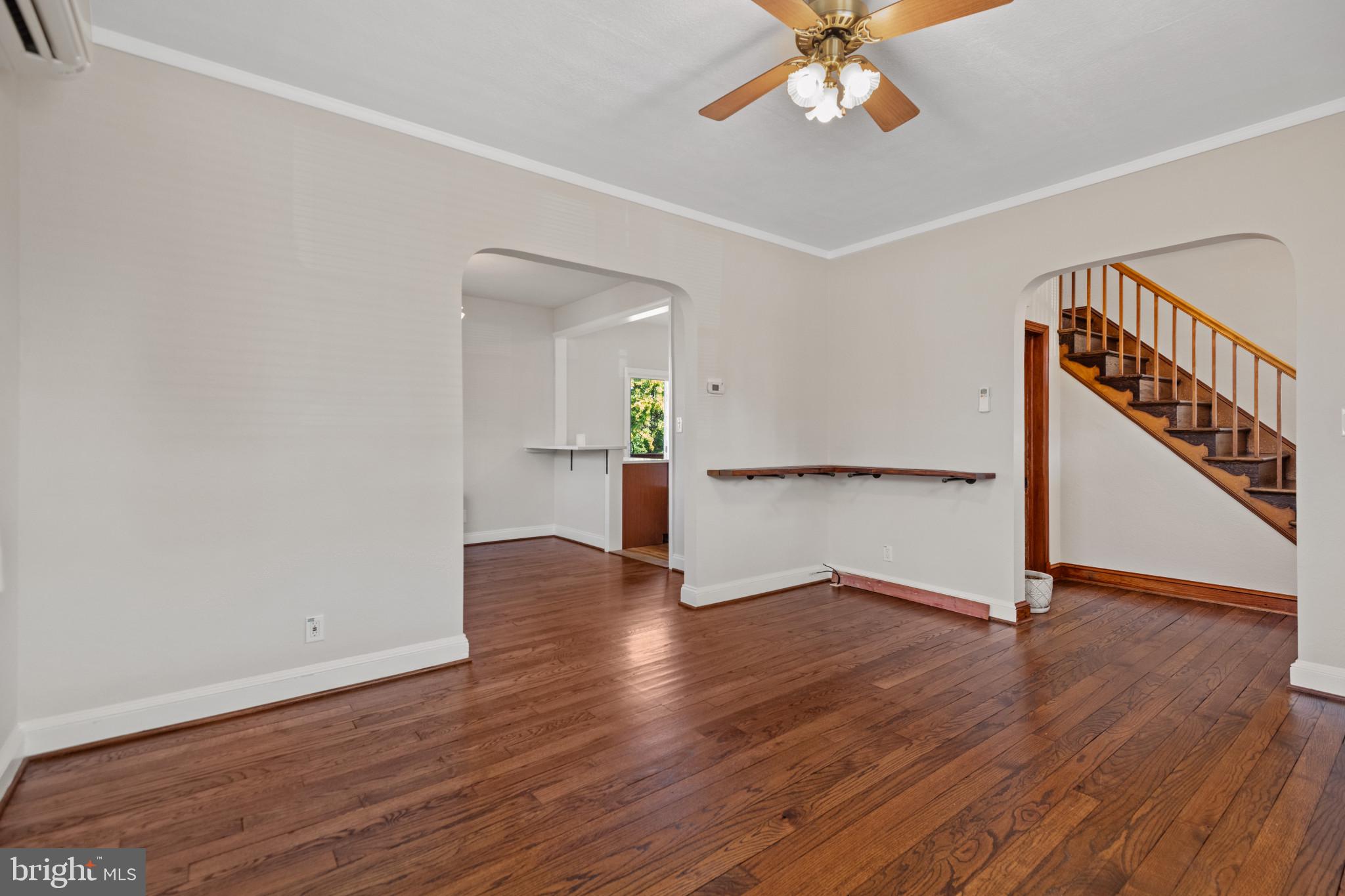 1260 June Road Baltimore, MD 21227 - Photo 6 of 32 a view of an empty room with wooden floor and a chandelier fan