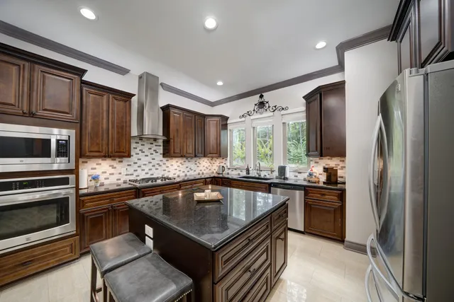 a kitchen with granite countertop a sink and a stove