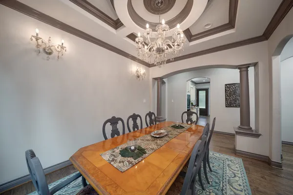 a view of a dining room with furniture and chandelier