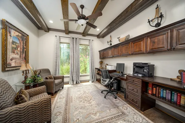 a view of a livingroom with furniture staircase and windows