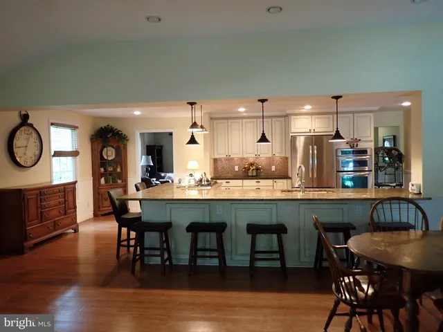a dining table with chairs and wooden floor