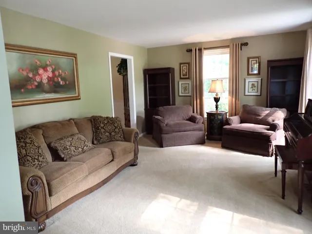 a living room with furniture a couch and a window