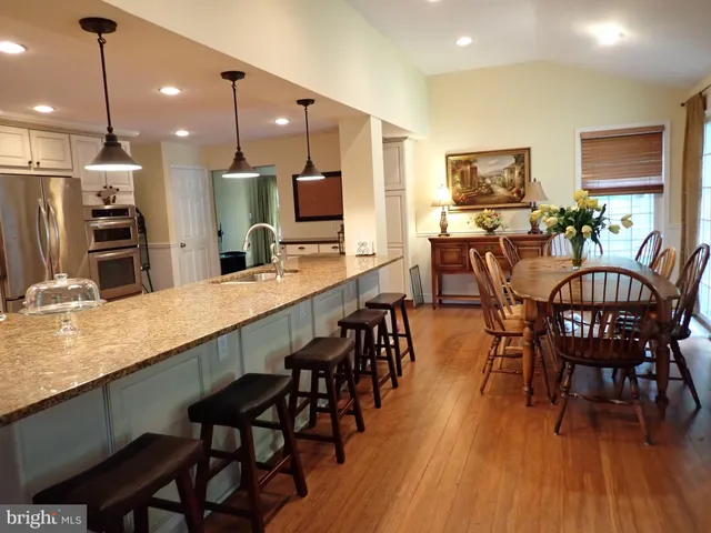 a large kitchen with a table and chairs
