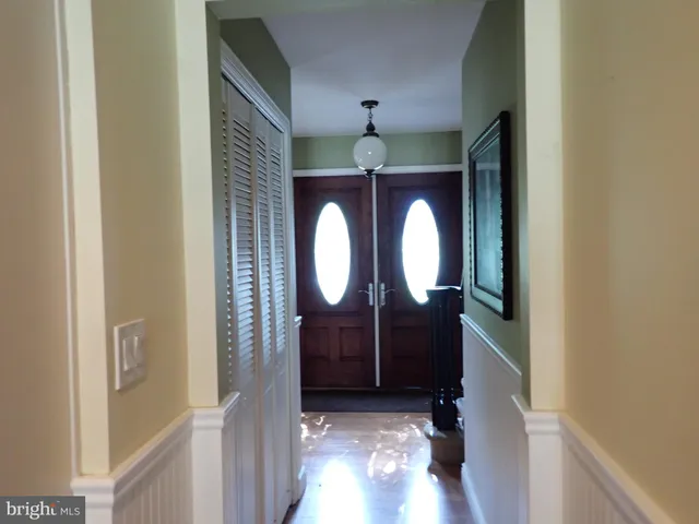 a view of a entryway door with wooden floor