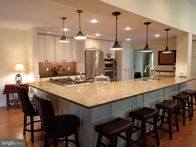 a kitchen with center island and chairs