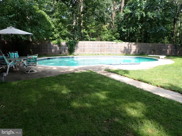 a view of backyard with outdoor seating and green space