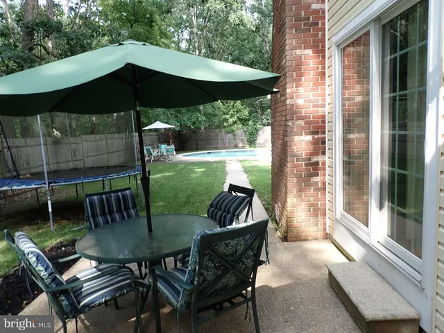 a view of an outdoor sitting area with furniture and backyard