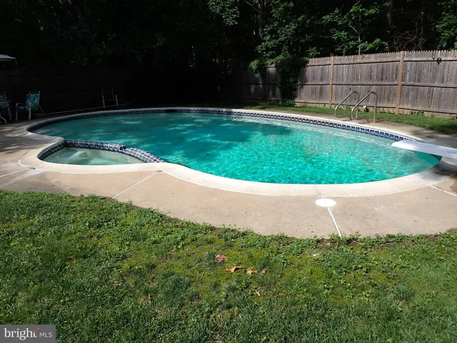 a view of pool with a yard