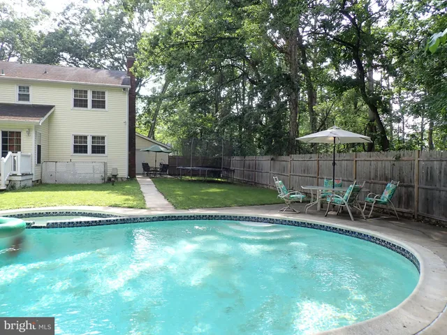 a view of a house with swimming pool and sitting area