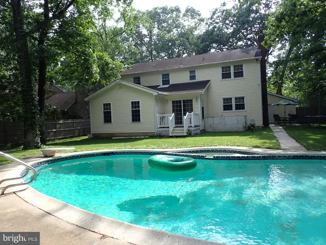 a view of house with a swimming pool
