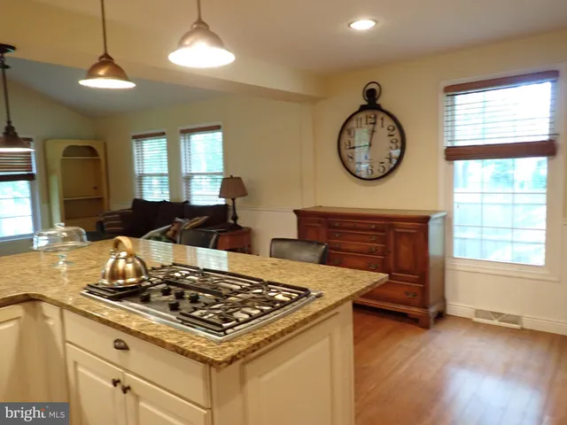 a kitchen with a stove and a clock on the wall
