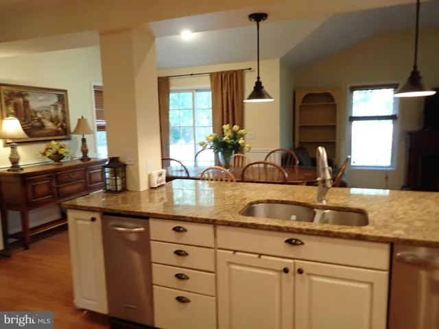 a kitchen with sink and mirror