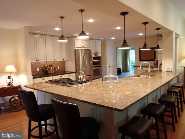 a kitchen with a table chairs sink and cabinets