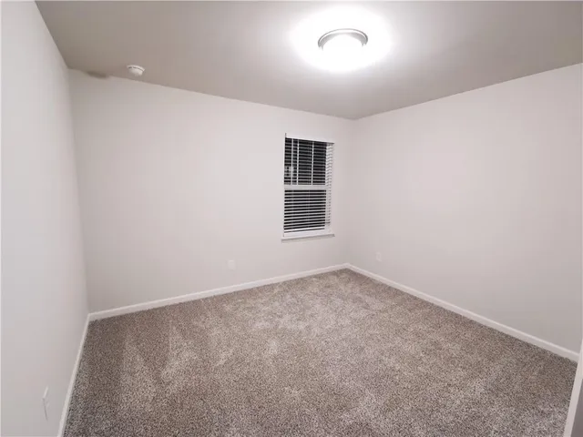 an empty room with a empty space and windows