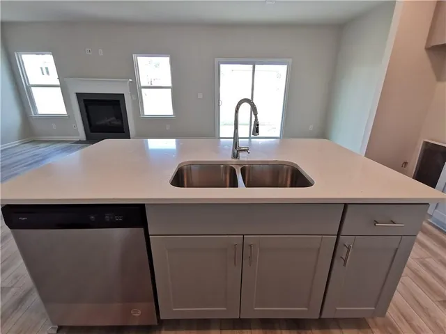 a kitchen with a sink and a fireplace