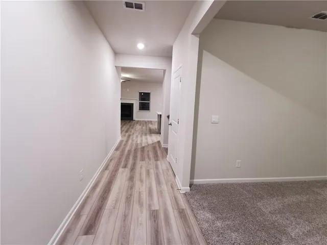 a view of a room with wooden floor and staircase