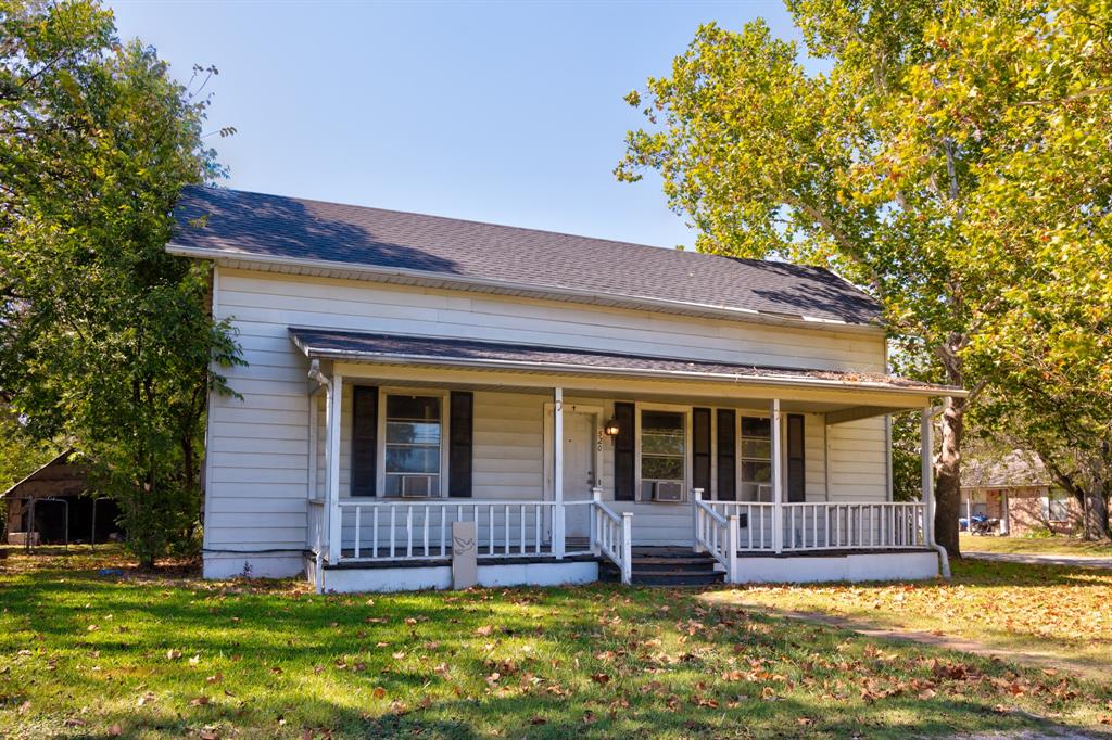 520 North Prairie Street Pilot Point, TX 76258 - Photo 1 of 1 a view of a house with a yard balcony and a tree