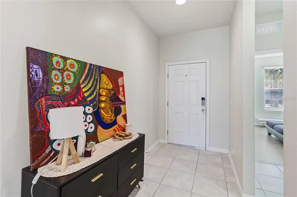 an entryway with a painting on the wall