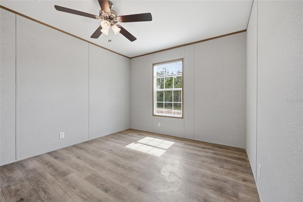 150 19th Street Interlachen, FL 32148 - Photo 27 of 30 an empty room with windows and fan