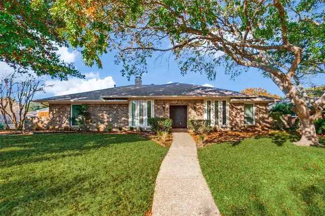 a front view of a house with a yard and porch