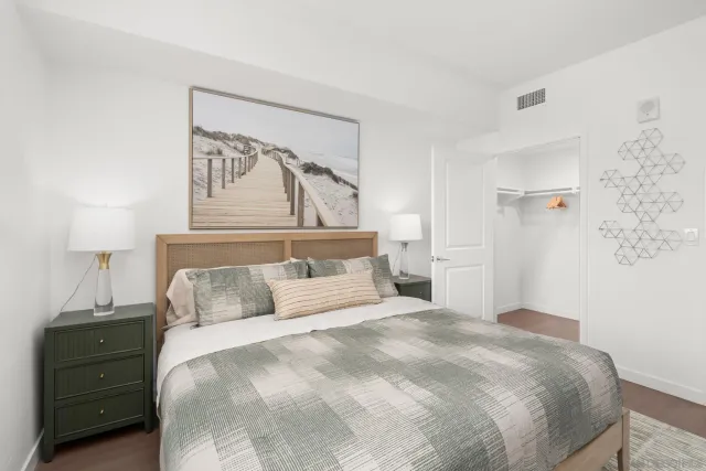 a bedroom with a bed and a night stand