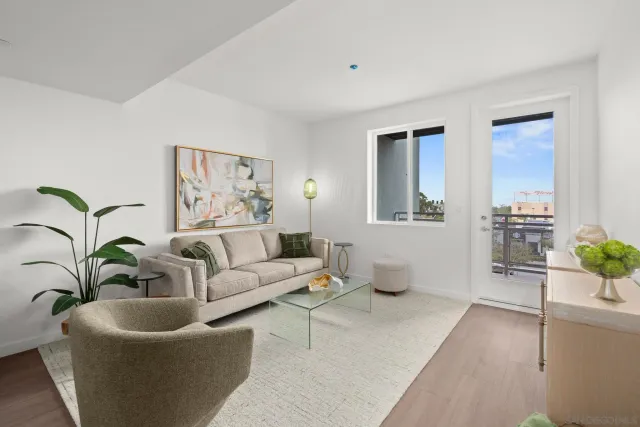 a living room with furniture and potted plant