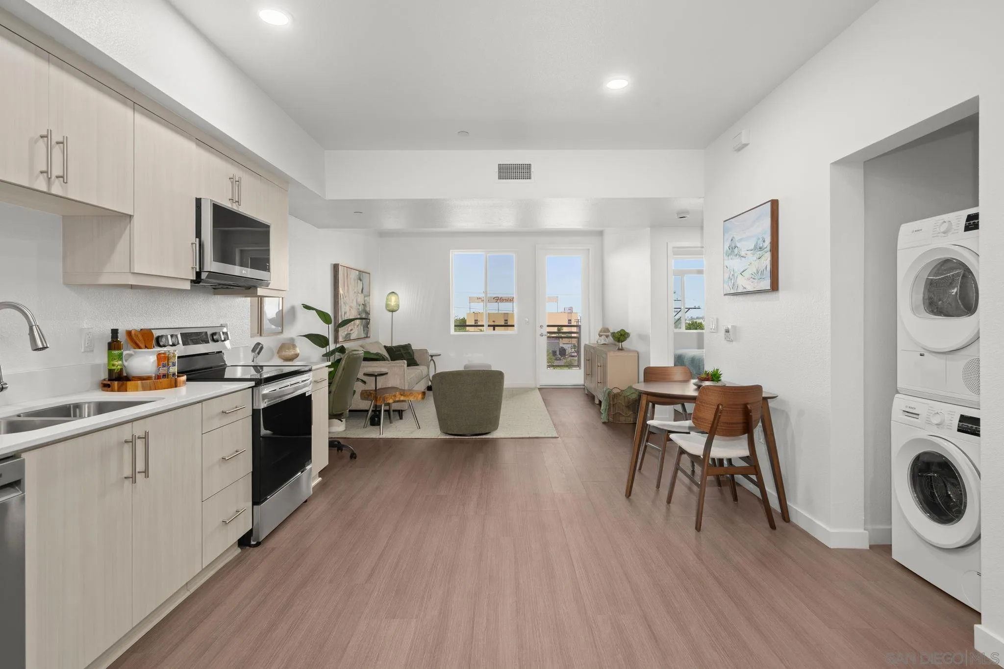 2724 El Cajon Boulevard, Unit 602 San Diego, CA 92104 - Photo 20 of 21 a kitchen with a dining table chairs a refrigerator and cabinets