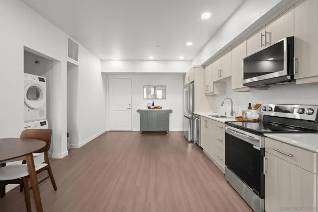 a kitchen with microwave a stove and cabinets