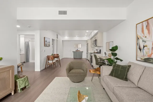a living room with furniture and wooden floor