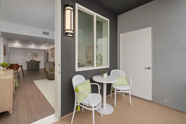 a dining room with furniture and a large window