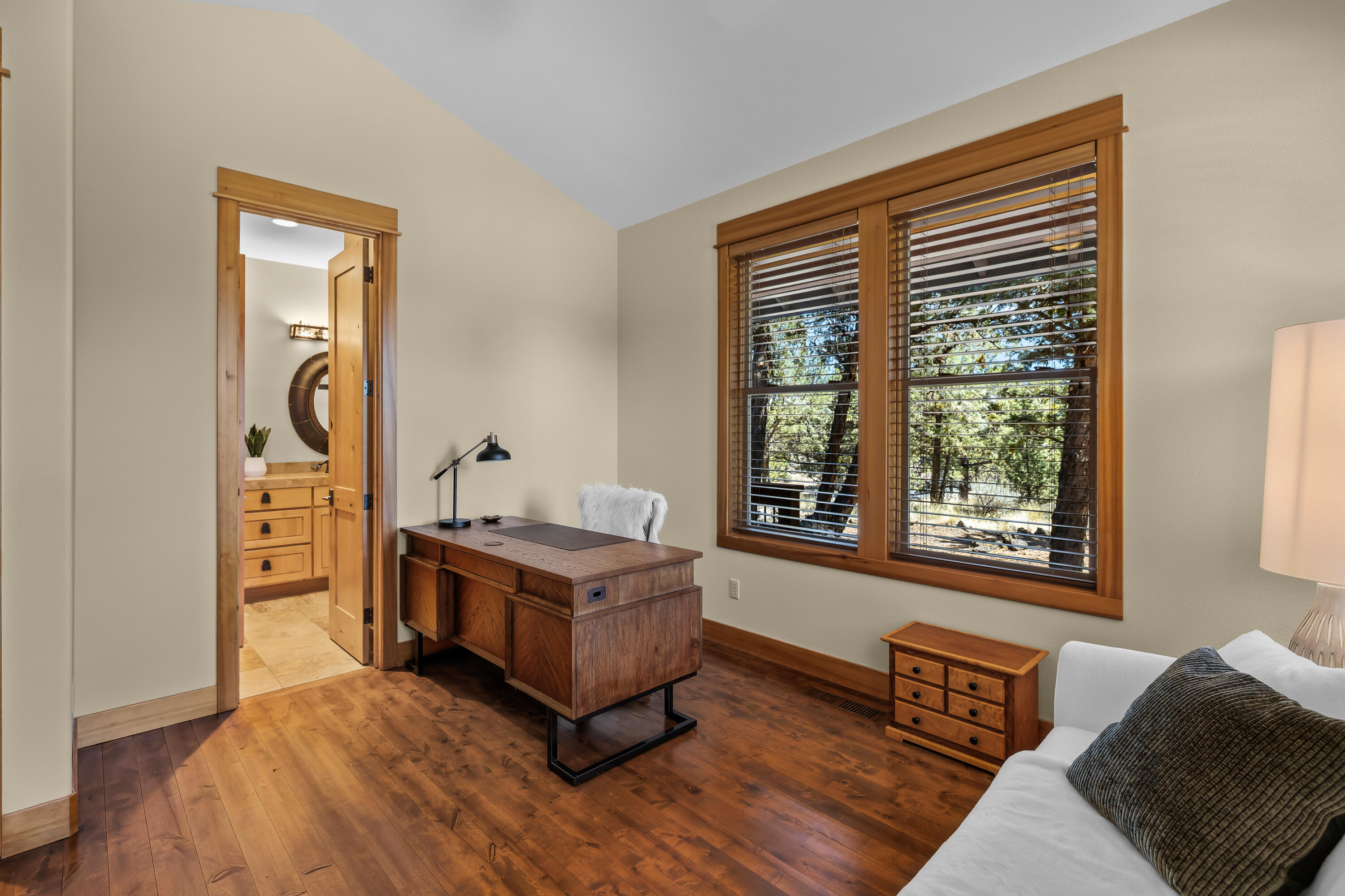 64145 Hunnell Road Bend, OR 97703 - Photo 34 of 65 The third bedroom offers comfortable flexibility for guests, office or hobby use, with wood floors, natural light and access to a full bath